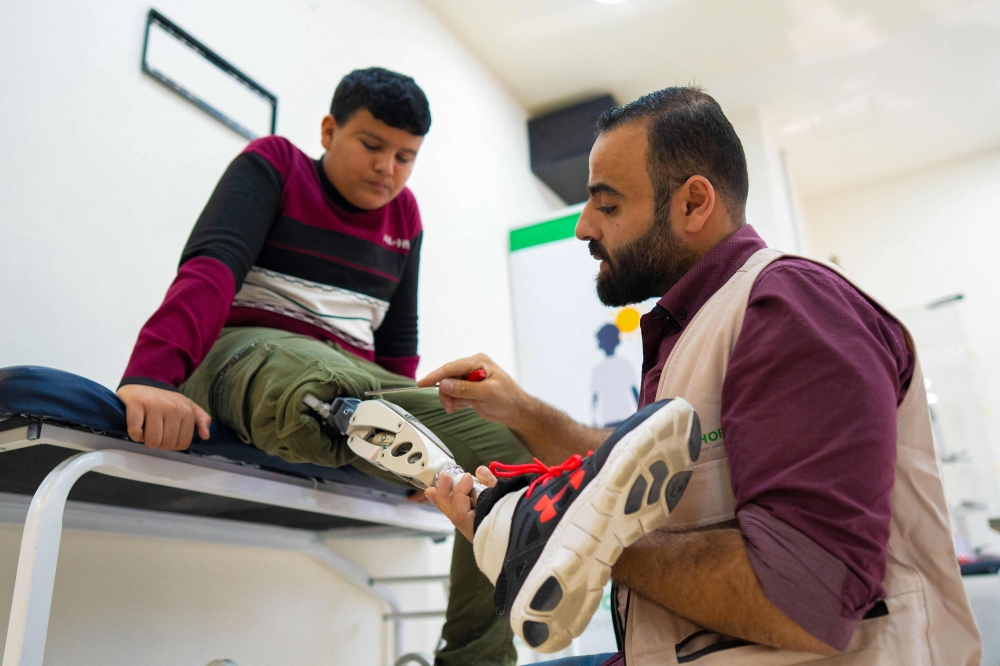 Mahmoud Abou Nusair has his prosthetic attached at a medical centre in Amman on October 13, 2026 as part of the 