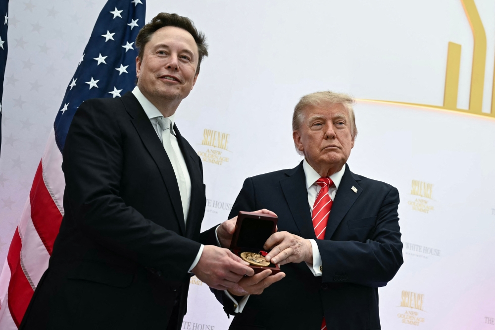 (Files) US President Donald Trump presents the National Medal of Science to Elon Musk during the 