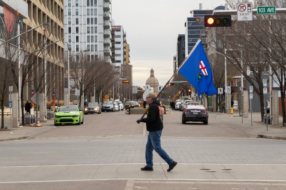 An Alberta separatist supporter carries a flag ahead of the referendum in downtown Edmonton, Alberta, on October 19, 2026. (Photo by Megan Albu / AFP)