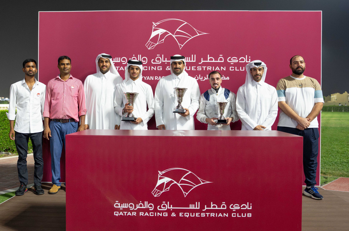 The connections of Keheilah Al Sakab pose with their trophies. Deputy Director of the QREC Registration and Studbook Department Saad Ali 
Al Kubaisi presented the Asherij Cup. PICS: Juhaim/QREC