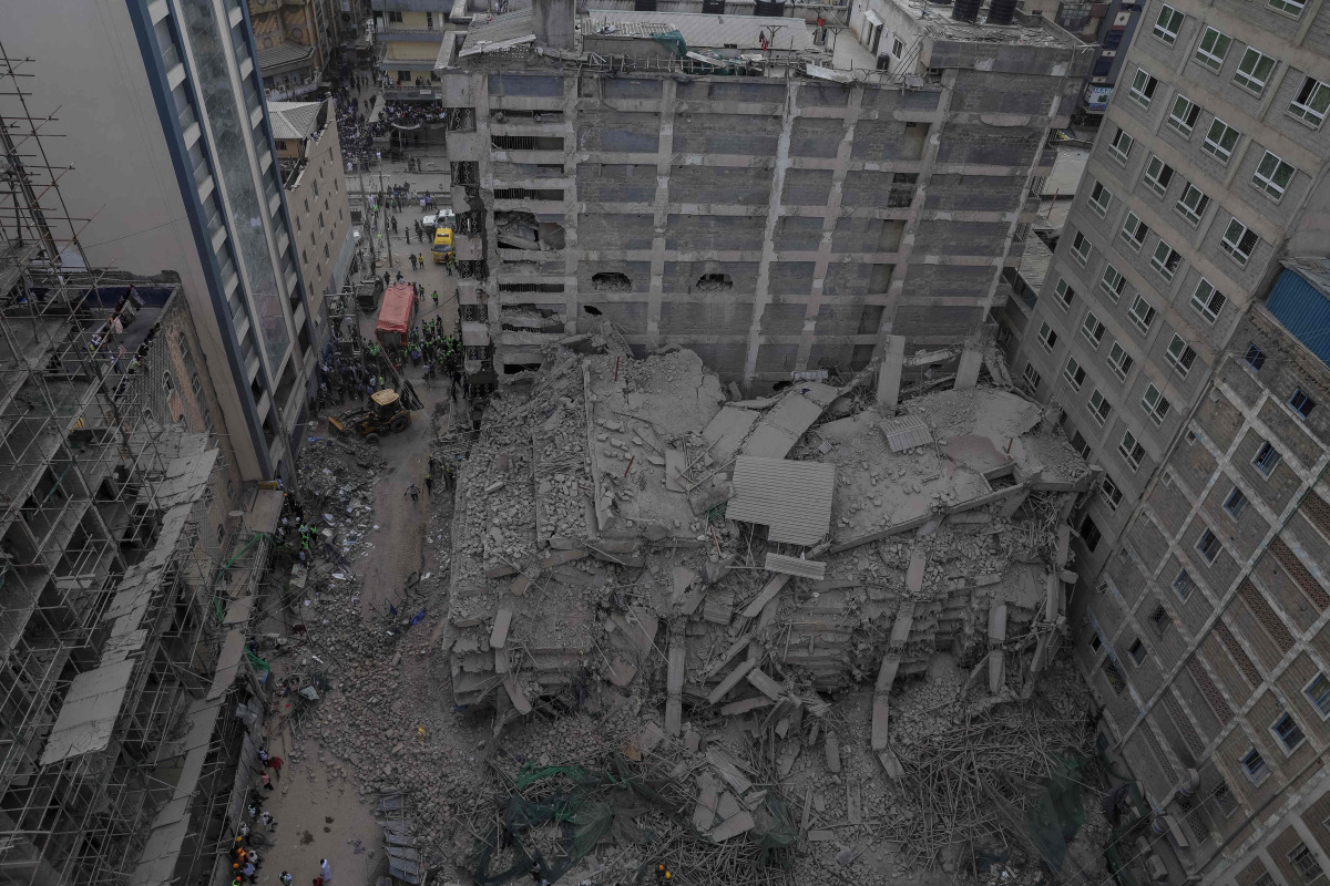 This aerial view shows personell from the Kenya Defence Forces Disaster Response Battalion inspecting the rubble of a collapsed residential building that was still under construction in the Eastleigh neighborhood of Nairobi on October 23,2026. Photo by Tony Karumba / AFP