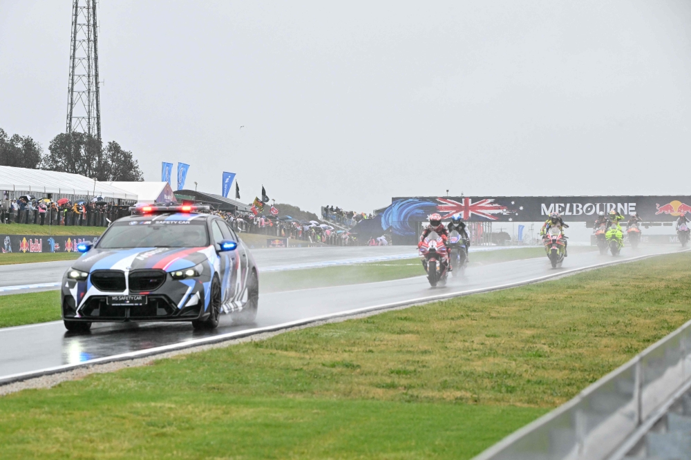 The safety car leads MotoGP riders in a farewell lap following the cancellation of the last Australian MotoGP Grand Prix to be held at Phillip Island on October 25, 2026, due to inclement weather conditions. (Photo by Paul Crock / AFP)