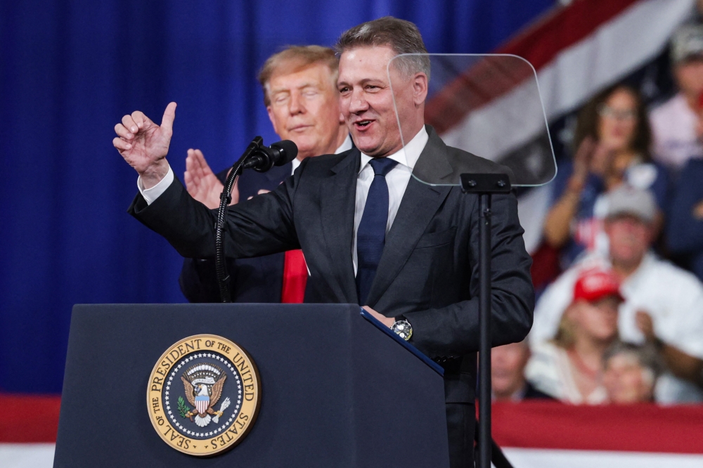 Audi AG CEO Gernot Dollner speaks alongside US President Donald Trump during a midterm campaign rally at the Guardian Centers on October 24, 2026 in Perry, Georgia. Alex Wong/Getty Images/AFP 