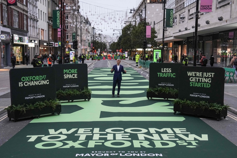London Mayor Sadiq Khan (C) attends the opening ceremony for a section of Oxford Street, as it goes permanently traffic-free for the first time in central London on October 26, 2026. (Photo by Carlos Jasso / AFP)