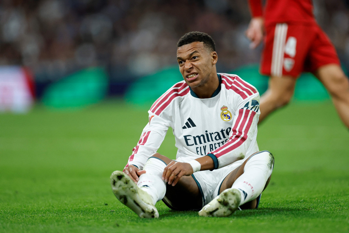 Real Madrid's French forward #10 Kylian Mbappe reacts on the ground during the Spanish league football match between Real Madrid CF and Sevilla FC at the Santiago Bernabeu stadium in Madrid on October 18, 2026.(Photo by Oscar DEL POZO / AFP)
