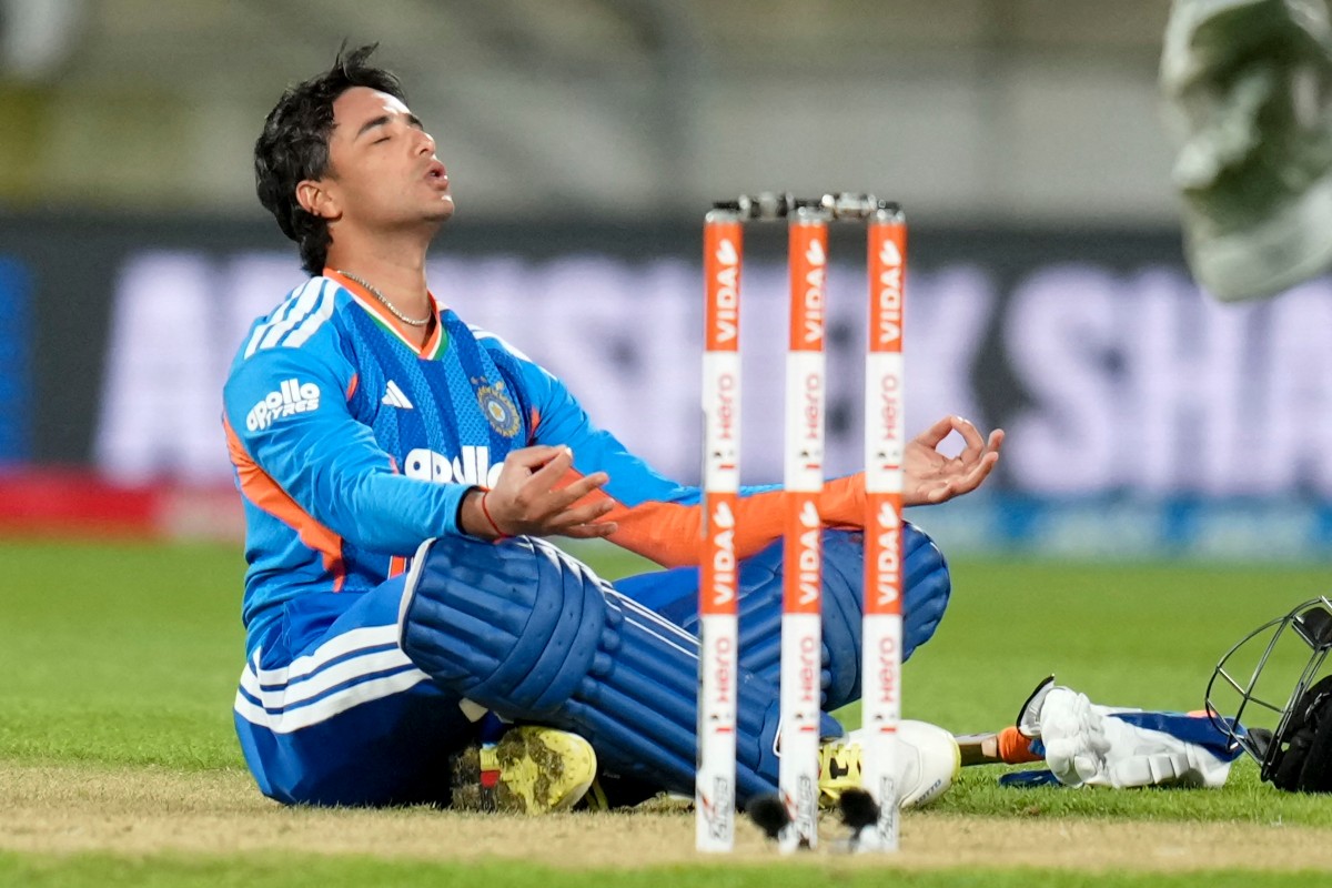 India's Abhishek Sharma celebrates after reaching his century in Wellington on October 27, 2026. (Photo by Marty Melville / AFP)