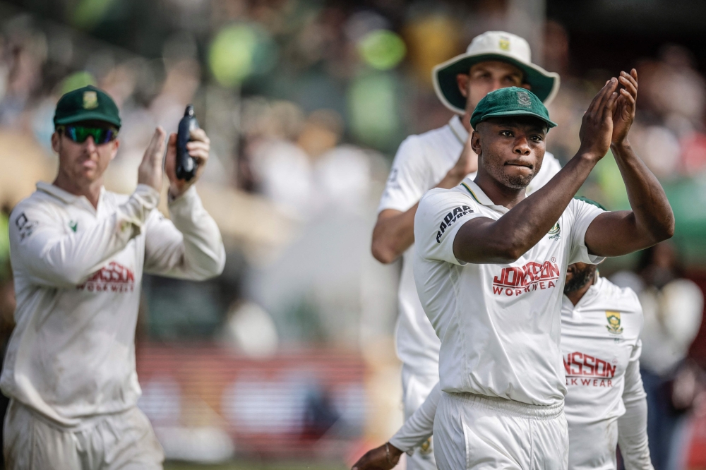 South Africa's Kagiso Rabada (R) and his teammates acknowledge the crowd after winning the match. (Photo by Marco Longari / AFP) 